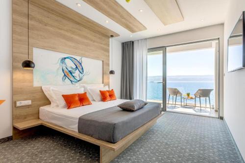 a bedroom with a bed with a view of the ocean at Hotel Saint Hildegard in Omiš