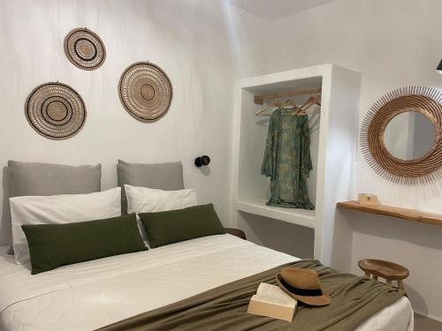 a bedroom with a bed with a hat on it at Konstantza's Elegant Apartment in Naxos Chora