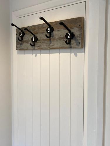a door with four numbers on it with a wood bracket at Pantiles in Eyke
