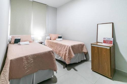 a room with two beds and a mirror at Casa Água Branca, Contagem - prox.arena MRV in Contagem