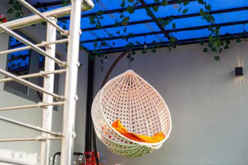 a net hanging from a wall with oranges in it at Book Atelier Lux Homes! Modern Service Apartment with Amazing Balcony View in Ibadan
