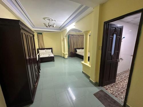 a hallway with a room with two beds and a door at Khách Sạn Ngân Hà in Ho Chi Minh City