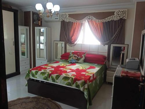 a bedroom with a bed with a teddy bear on it at شقة فندقية in Qaryat ash Shamālī