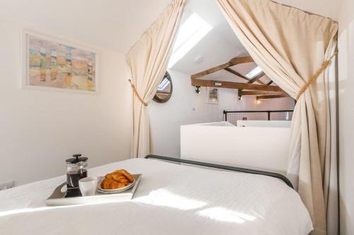 a room with a bed with a bowl of food on it at The Coach House - Central Hexham in Hexham