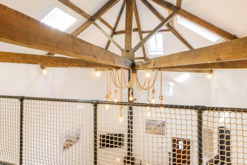 a barn with a fence in a room at The Coach House - Central Hexham in Hexham