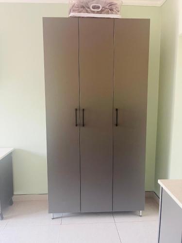 a large gray cabinet in a kitchen at TrendyBliss Guest House in Northam