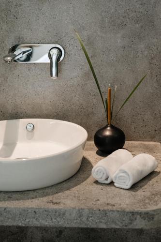 a bathroom sink with two towels on a counter at Māna in Atadahewatugoda