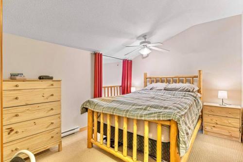 um quarto com uma cama de madeira e uma cómoda em Canmore Mountain view loft apartment heated outdoor pool em Canmore