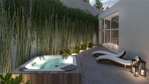 a bathroom with a jacuzzi tub next to a building at departamento concon in Concón