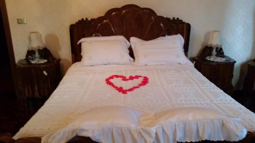 a bedroom with a bed with a heart on it at Villa Storica Calderino in Monte San Pietro