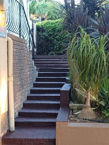 a set of stairs leading up to a building at Strandloper Room in Cape Town