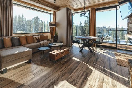a living room with a couch and a table at Pensjonat Orlik Mountain Resort&SPA in Bukowina Tatrzańska