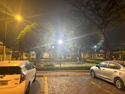 two cars parked in a parking lot at night at Suite Bosque de la Alborada B in Guayaquil