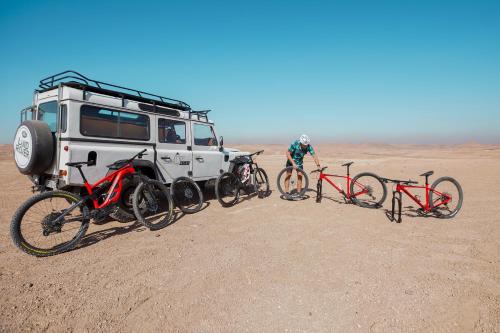 a group of bikes parked next to a truck in the desert at La Fattoria Ecolodge in Lalla Takerkoust