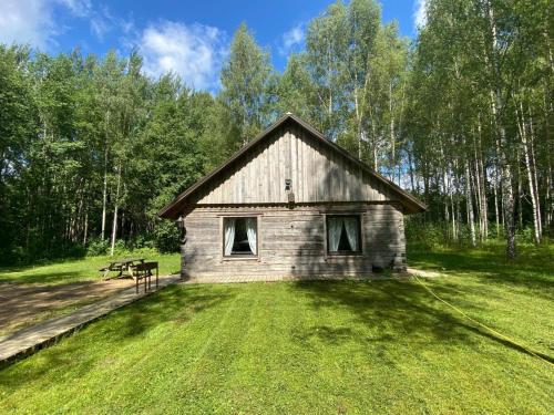 a small building in the middle of a field at Pirts Muzejs 