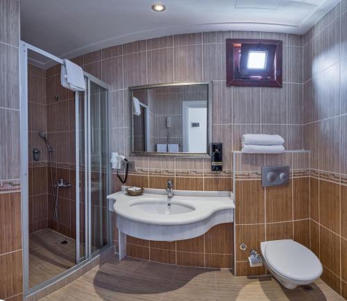 a bathroom with a sink and a shower and a toilet at Green Anka Hotel in Istanbul