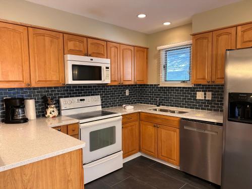 a kitchen with white appliances and wooden cabinets at 68 Inlet Cove in Kiawah Island
