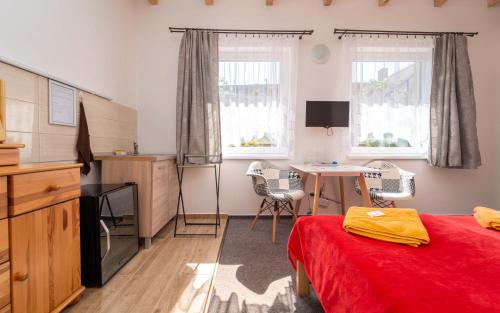 a bedroom with a bed and a desk in it at Penzion Alenka Valtice in Valtice