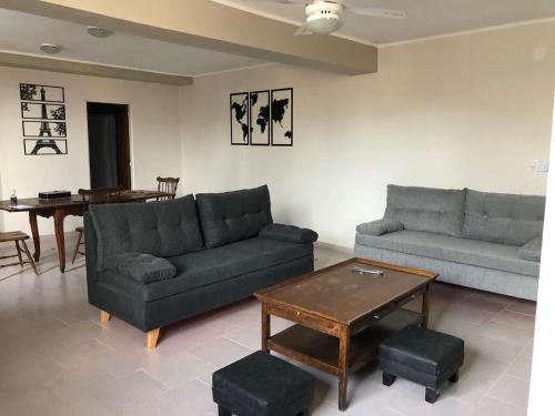 Sala de estar con 2 sofás y mesa en La Comarca Aparts Alojamiento en Colón