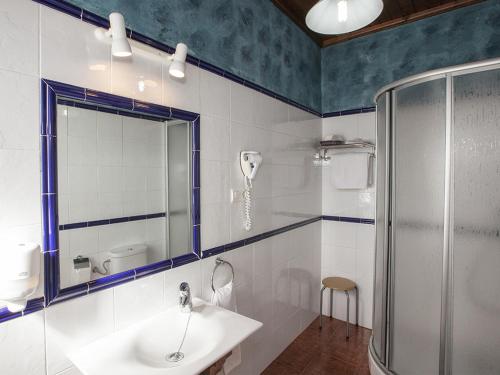 a bathroom with a sink and a shower at La Casona de Sobrepiedra in Sobrepiedra