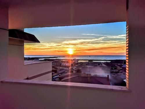 a view of a sunset from a window at VUEL SEA VIEW HOUSE -10 Minutes from the Airport Fiumicino in Fiumicino