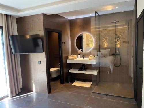 a bathroom with a sink and a mirror at Domaine de La Franquette by Bridget & Pascal - Piscine Chauffée & SPA in Caderousse