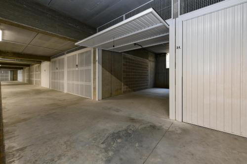 an empty garage with a brick wall at New Apartment Lazise in Lazise