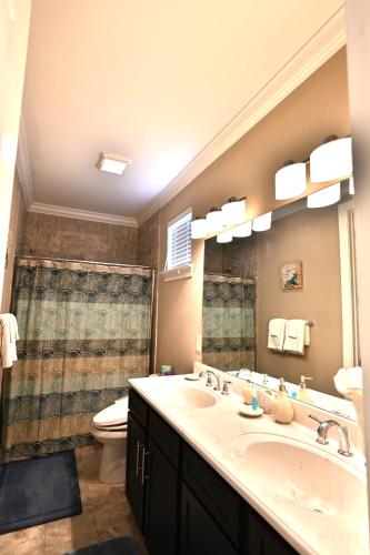 a bathroom with a sink and a toilet and a mirror at Spacious House near the Beach 300 in Myrtle Beach