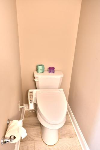 a bathroom with a toilet with two candles on it at Spacious House near the Beach 300 in Myrtle Beach