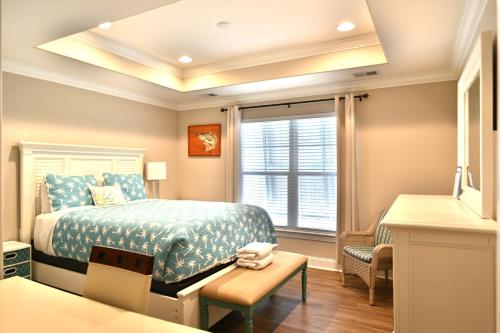 a bedroom with a bed and a window and a table at Spacious House near the Beach 300 in Myrtle Beach