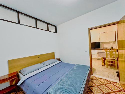 a bedroom with a bed with a large window at residenza piccolo diamante a 300m dal centro in Borno