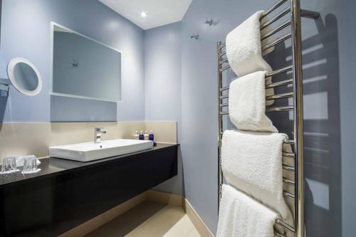 a bathroom with a sink and a mirror at Budock Vean Hotel in Falmouth