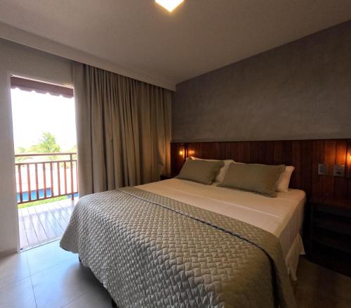 ein Schlafzimmer mit einem Bett und einem großen Fenster in der Unterkunft Pousada do Nica in Fernando de Noronha