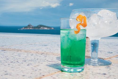 a drink in a glass sitting on a table at Windsor Barra Hotel in Rio de Janeiro