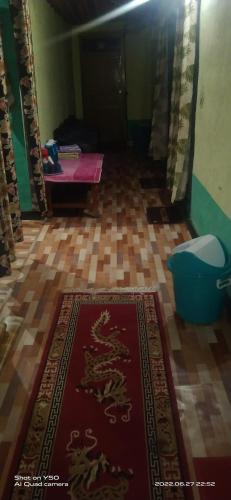 a room with a carpet with a dragon on the floor at Sunflower in spiti kee in Kibar