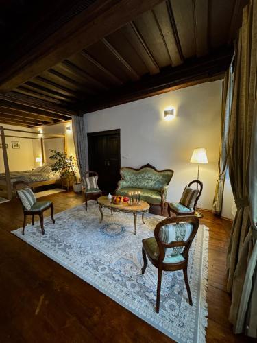 a living room with a couch and a table and chairs at Maison Český Krumlov in Český Krumlov