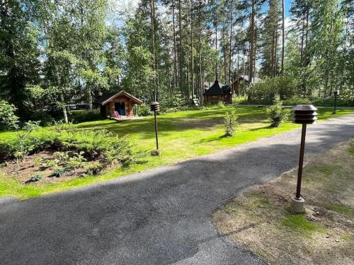 a road with two parking meters in front of a cabin at Villa Kalajärvi in Seinäjoki