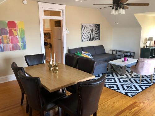 a living room with a table and a couch at Knight Campbell Carriage House in Denver