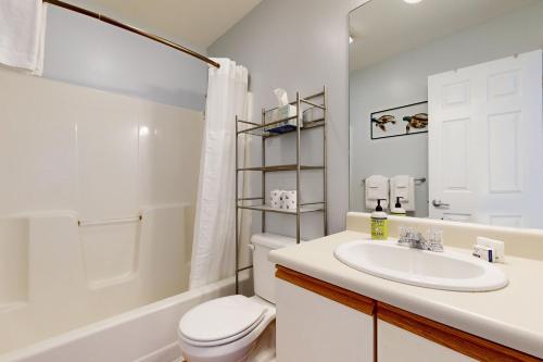 a white bathroom with a sink and a toilet at Hibernation Station in Thornton