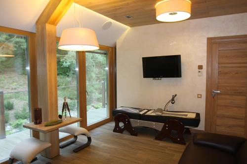 a living room with a bed and a tv at Kernavės Pajauta in Kernavė