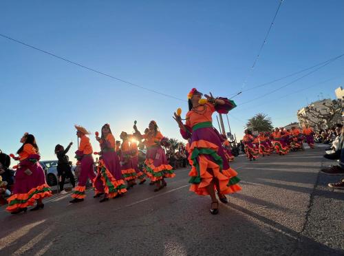 a group of women dancing in a parade at BLAU Apartamento frente a los canales y las puestas de sol de Roses in Roses