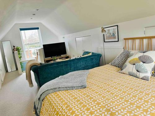 a bedroom with a large bed and a television at The Hideaway: Farnsfield (5 mins from Southwell) in Farnsfield