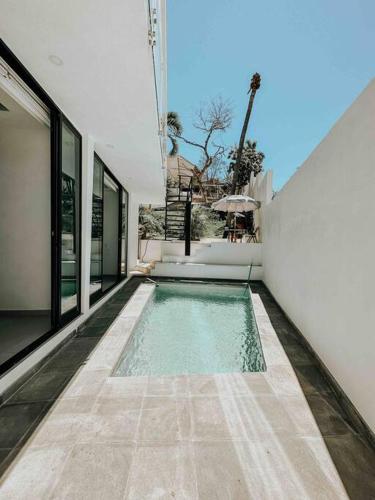 a swimming pool in the side of a house at Casa Calec 2BR Apartment with Pool & Terrace in Manzanillo