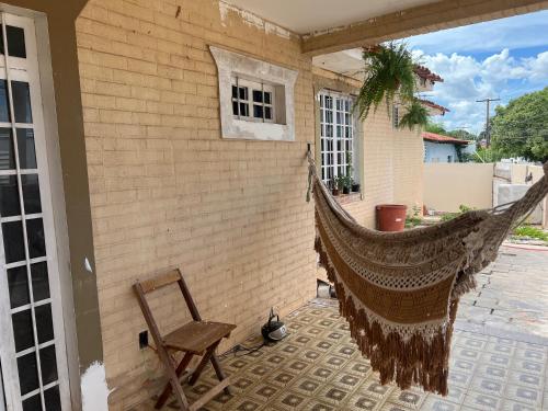una hamaca colgada en el lateral de una casa en Suíte Príncipe Charles Ceres0021, en Cuiabá