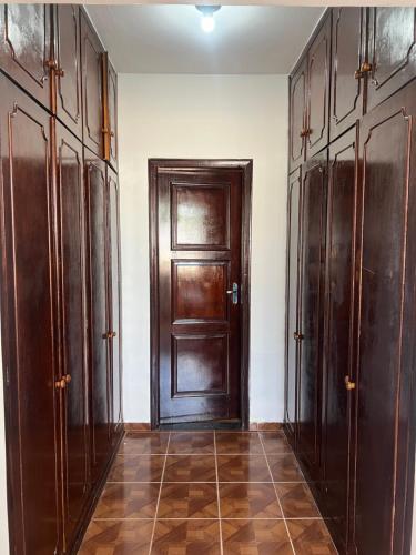 pasillo con puerta de madera en una habitación en Suíte Príncipe Charles Ceres0021, en Cuiabá