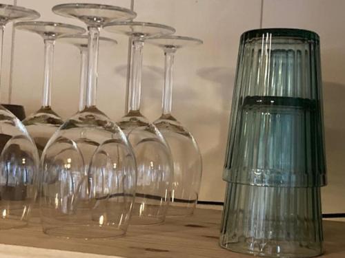 a group of wine glasses sitting on a table at Chalet Au bois du Haut Folin in Saint-Prix