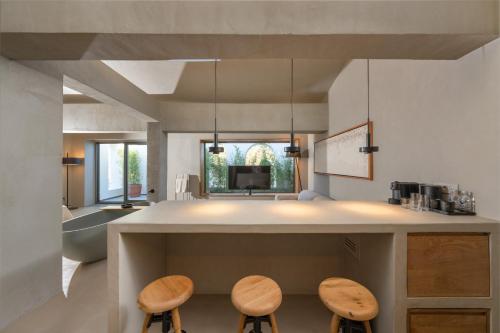a kitchen with two stools and a counter top at Roome in Fethiye