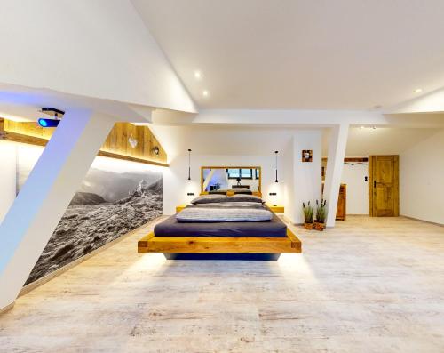 a bedroom with a bed and a painting on the wall at Ferienhaus Hennewinkl in Oetz