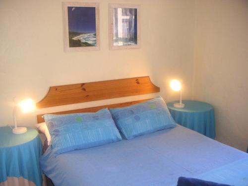 a bedroom with a bed and two lamps on tables at Waterside Living CL16 in Jeffreys Bay