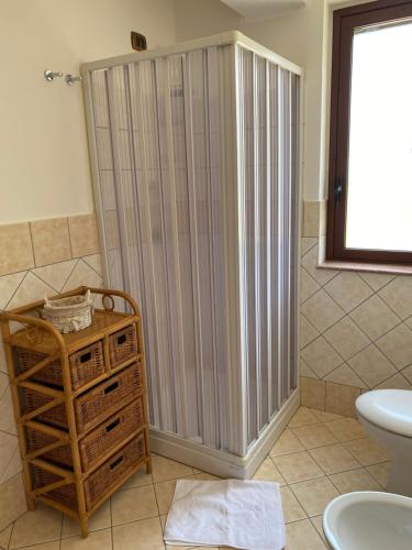 a shower in a bathroom with a toilet and a sink at Baglio Quadrone bovo Marina in Montallegro